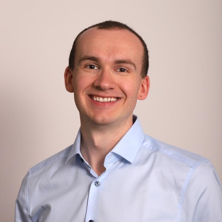 Ava Lee, Lead Design Curator at PressMillWorks, reviewing corporate floral arrangements